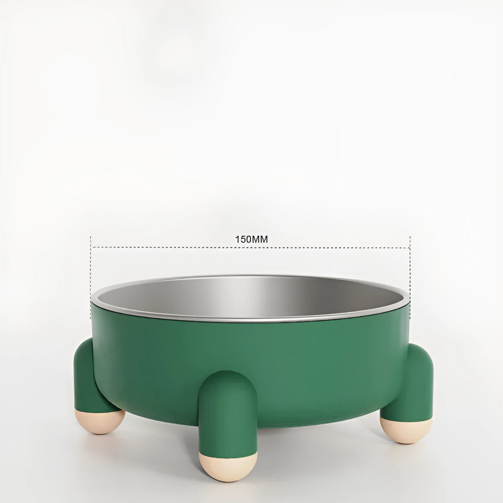 A green stainless steel pet bowl with a non-slip base and high foot, placed on a floor.