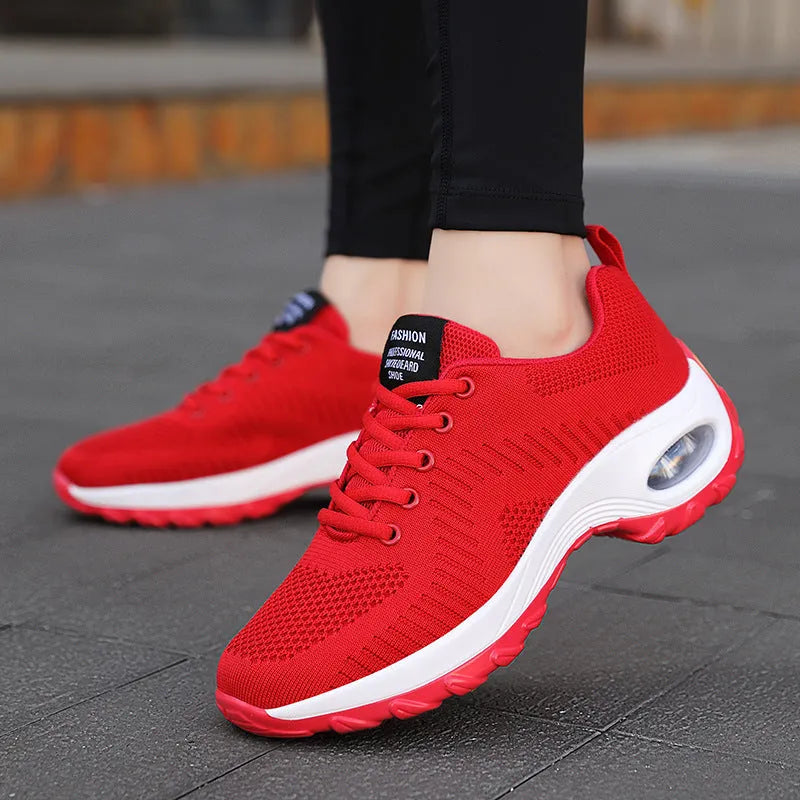Red and black women's low-top lace-up mesh sneakers with a round toe and mid heel on a PU sole.