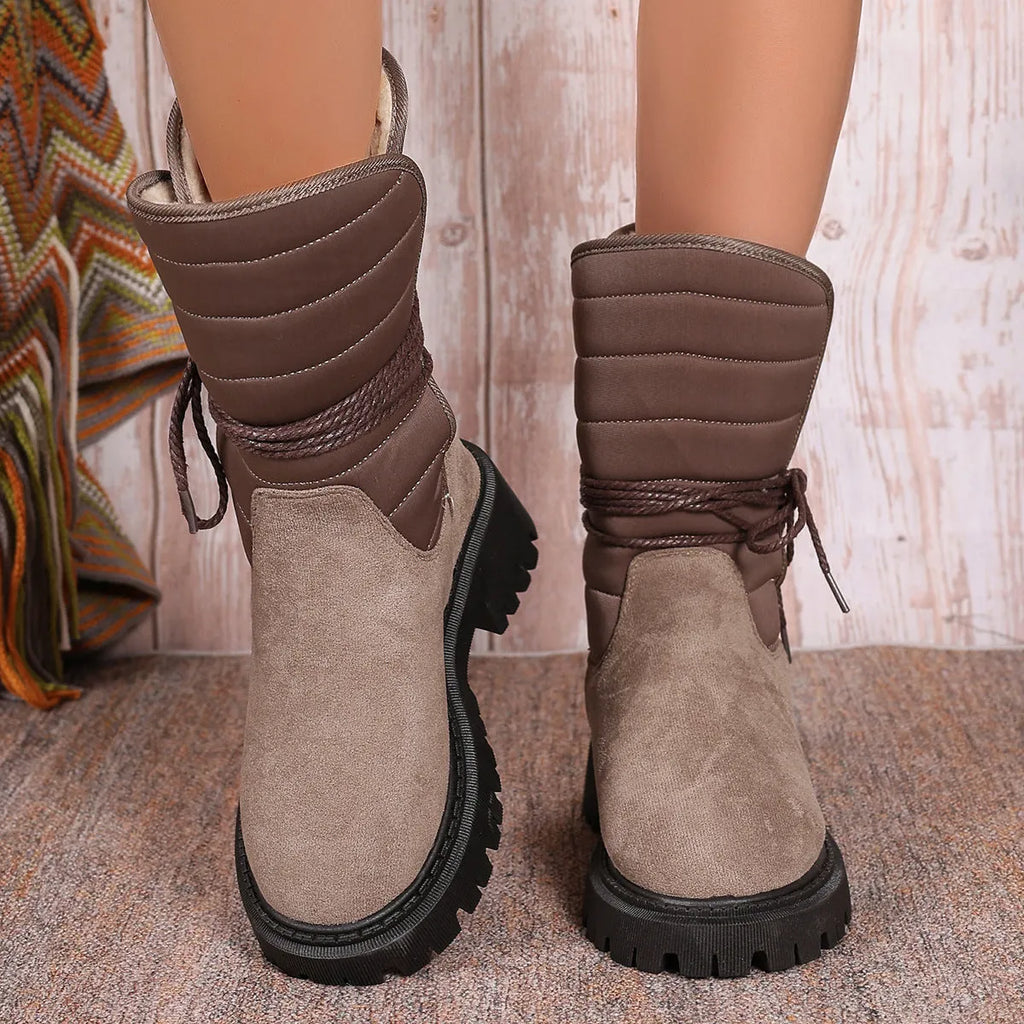 Women's black suede chunky heel mid-calf snow boot with lace-up front and fleece lining.