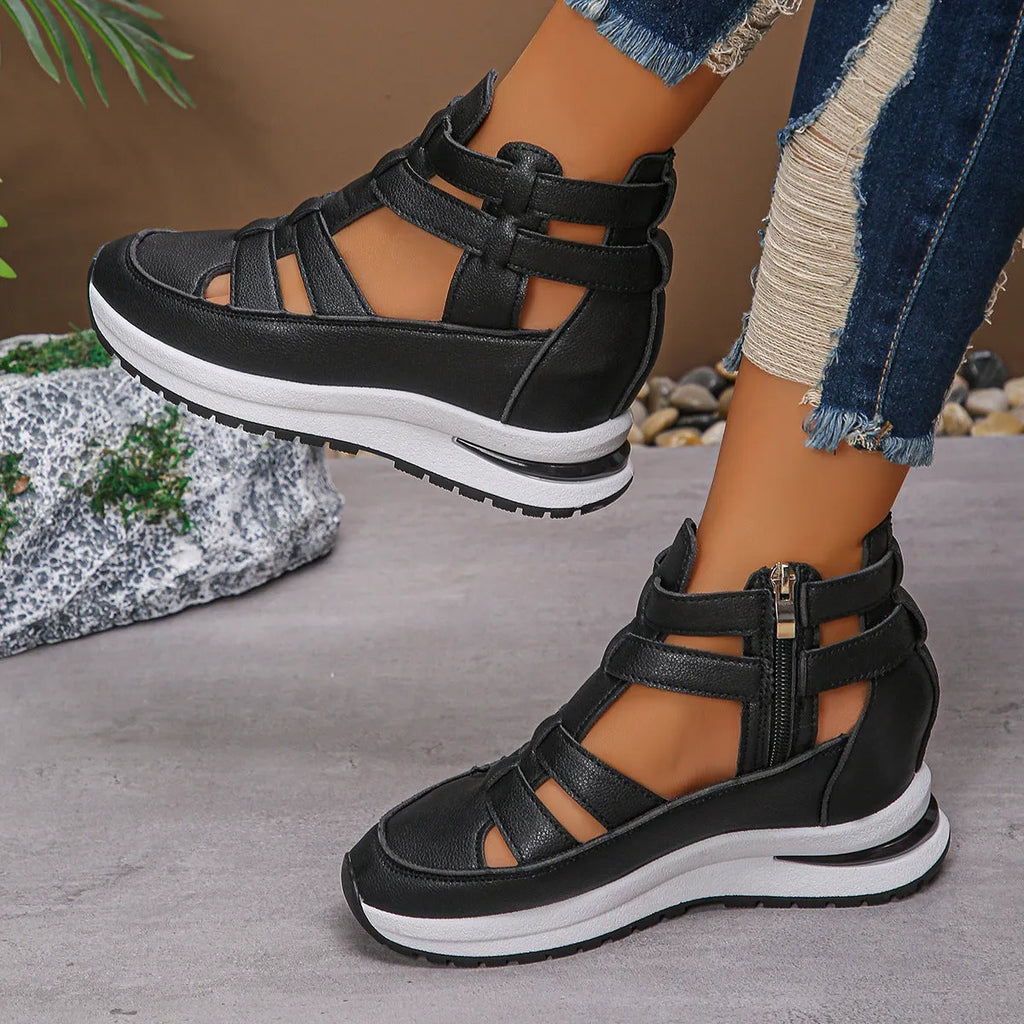 Black women's close-toed platform sandals with hollow-out design and Velcro strap on a white background.
