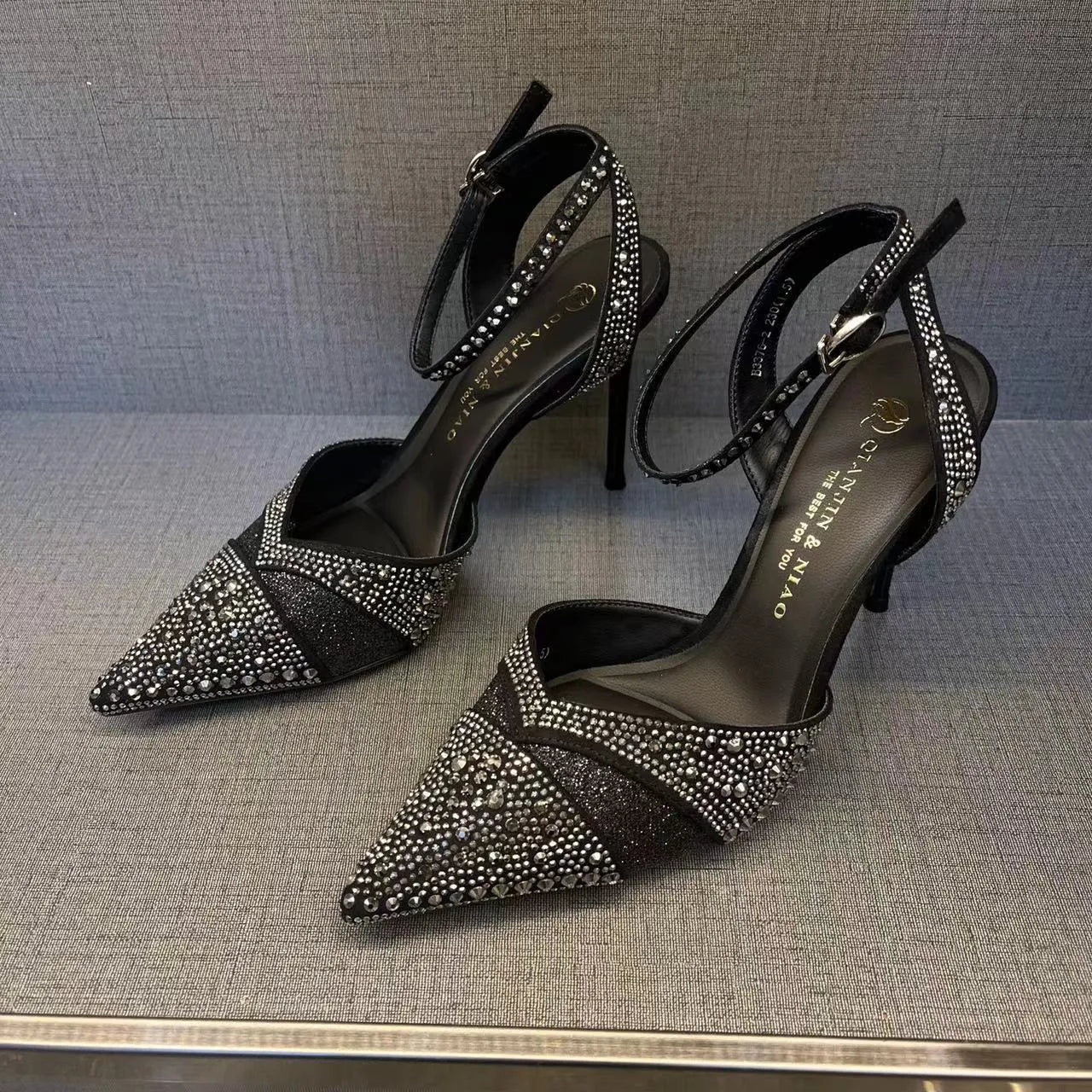 Women's black pointed-toe stiletto high heels with a hollow heel and red sole