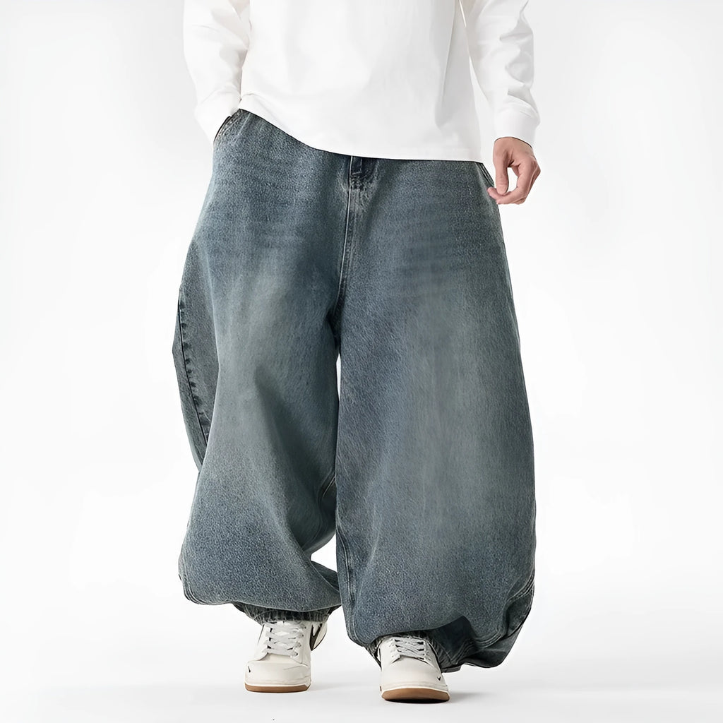 Man wearing light blue baggy fit denim jeans with a straight leg and low waist.