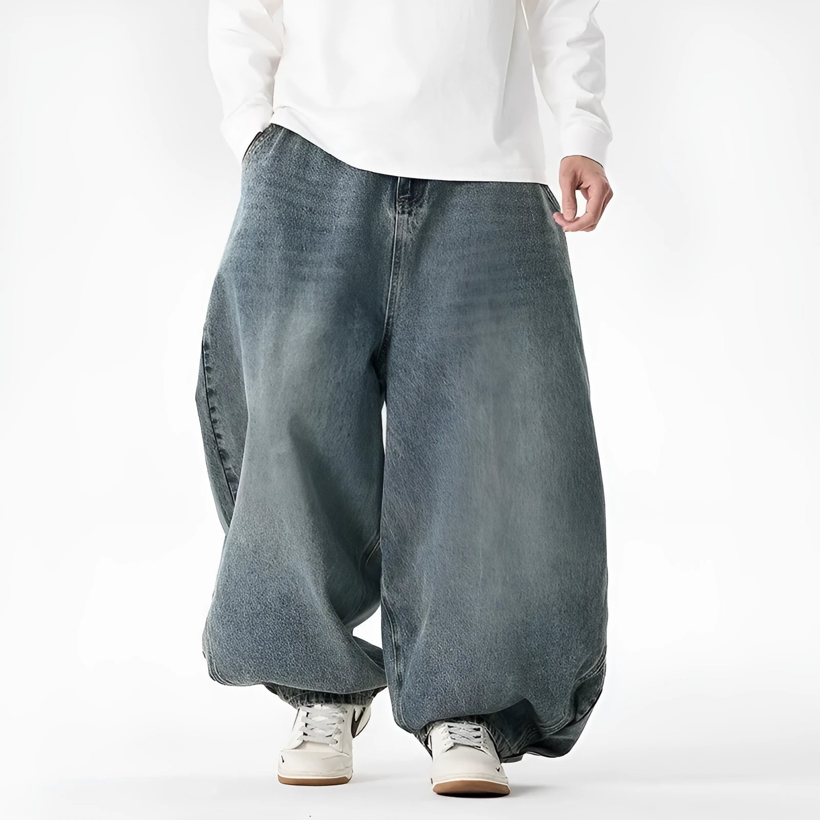 Man wearing light blue baggy fit denim jeans with a straight leg and low waist.