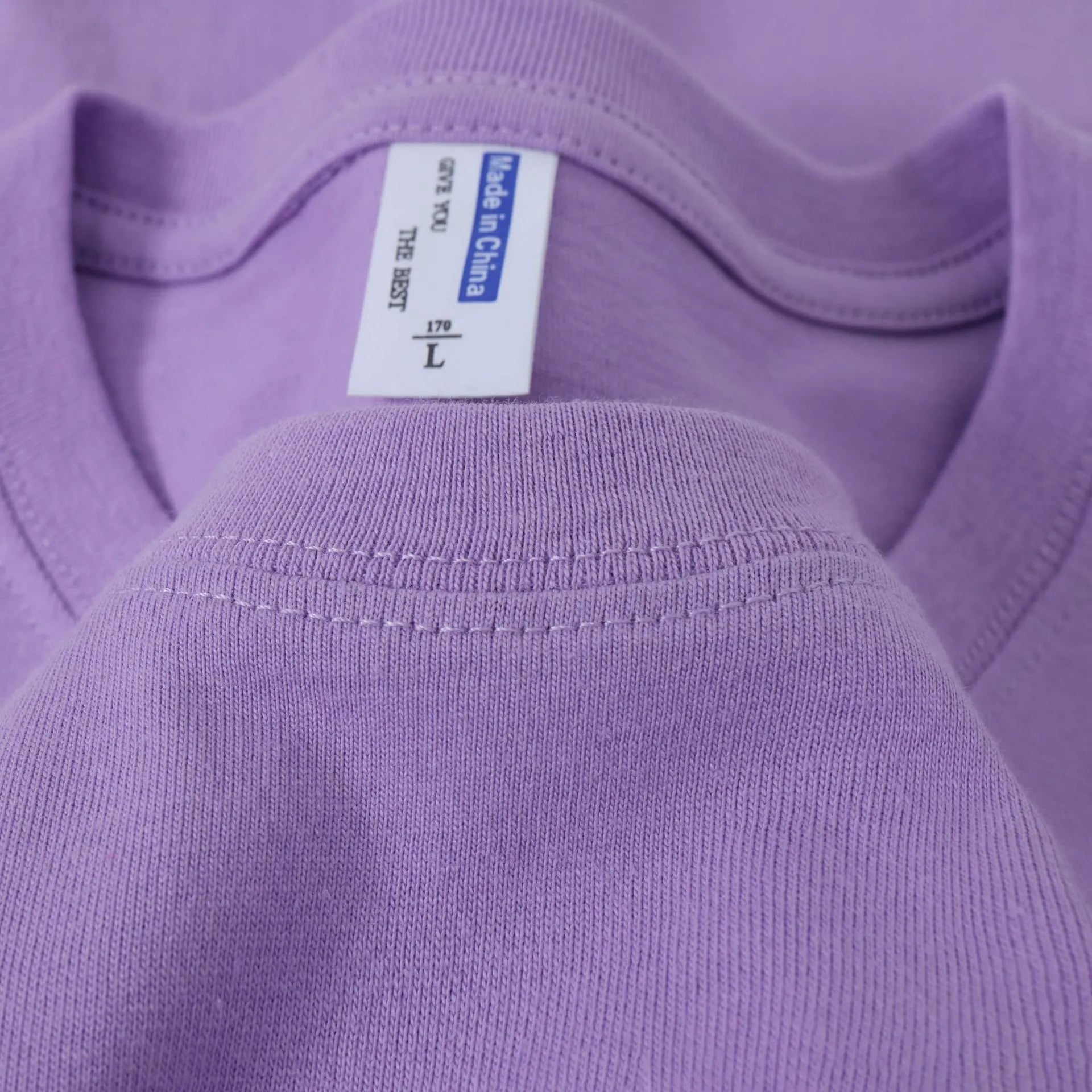 Men's and women's loose-fit cotton T-shirt in solid colours like navy blue, red, and white, shown as a short-sleeve pullover top.