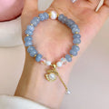 Natural aquamarine pearl shell bracelet on wrist showing adjustable design and handcrafted bead details
