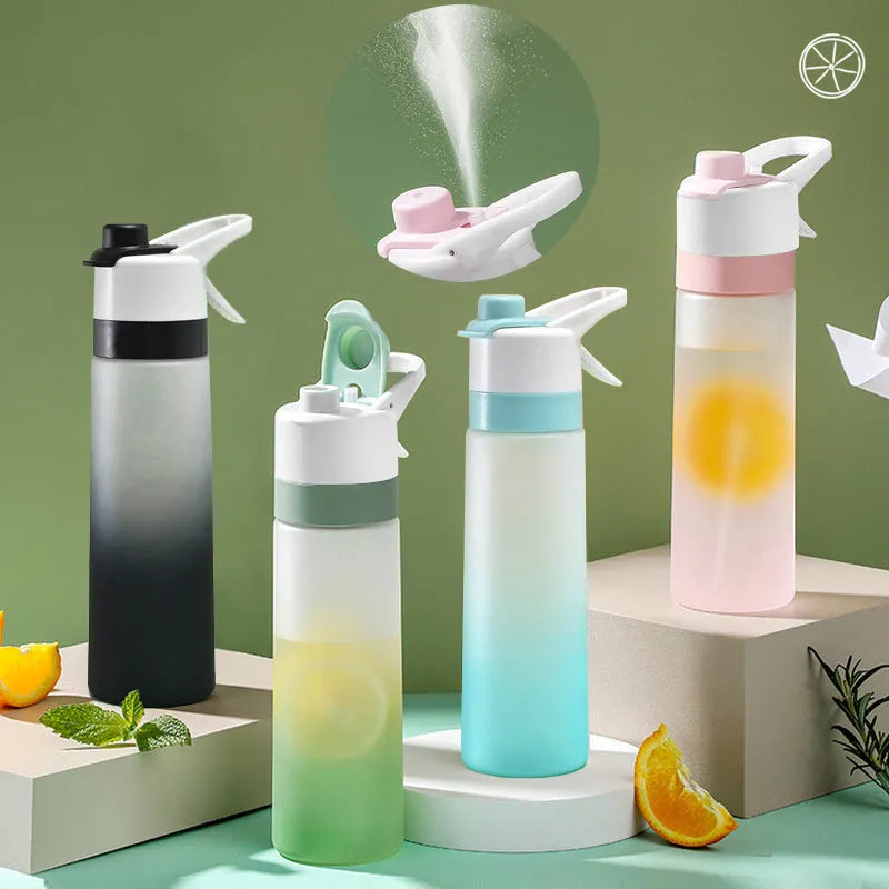 White 700ml plastic spray water bottle with a black handle strap and leakproof lid on a table.