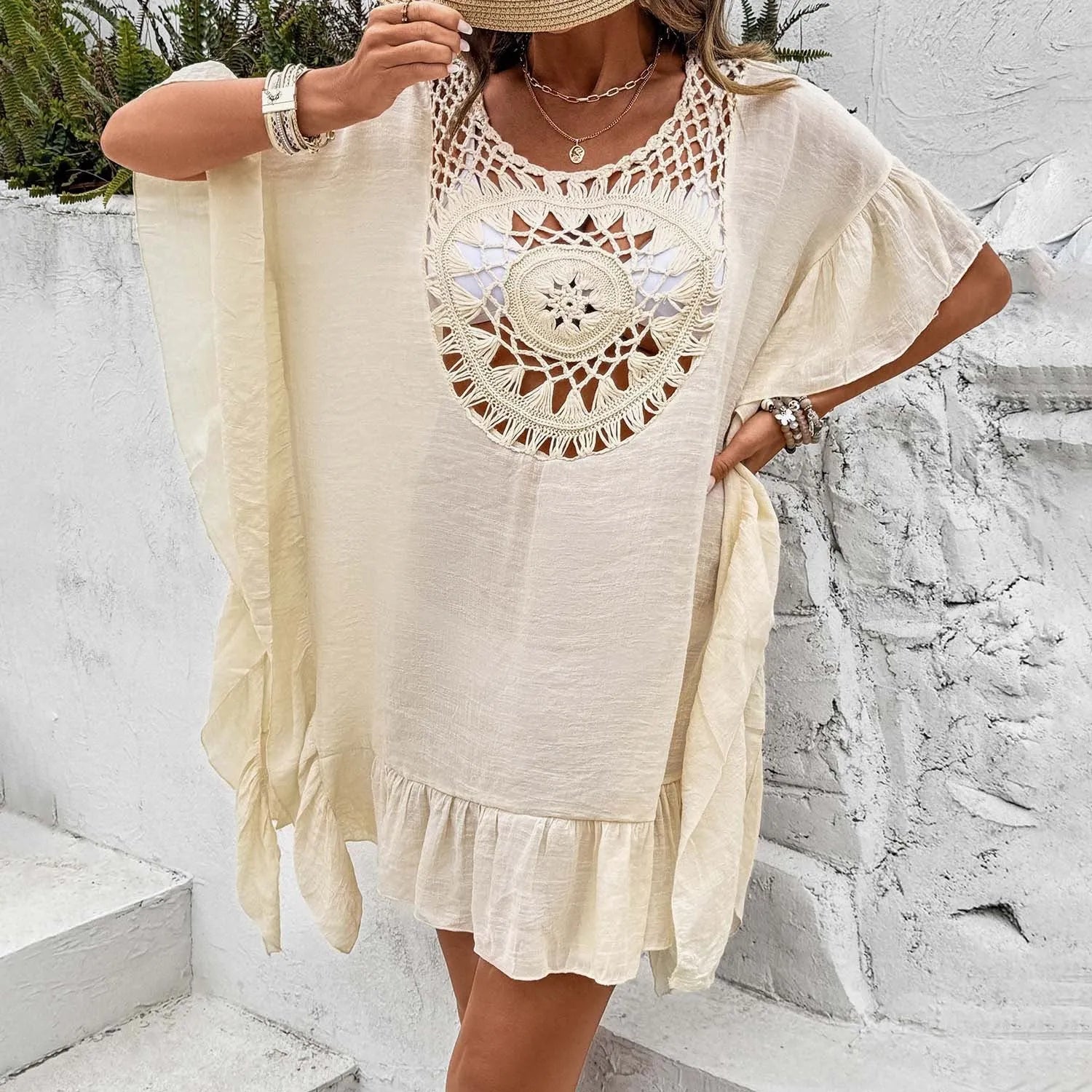 Apricot crochet stitch tassel dress on a hanger, showing patchwork skirt detail.