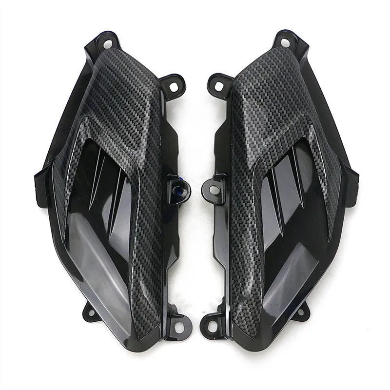 Pair of Yamaha NMAX side lamps with LED light and carbon fibre decoration on a black background.