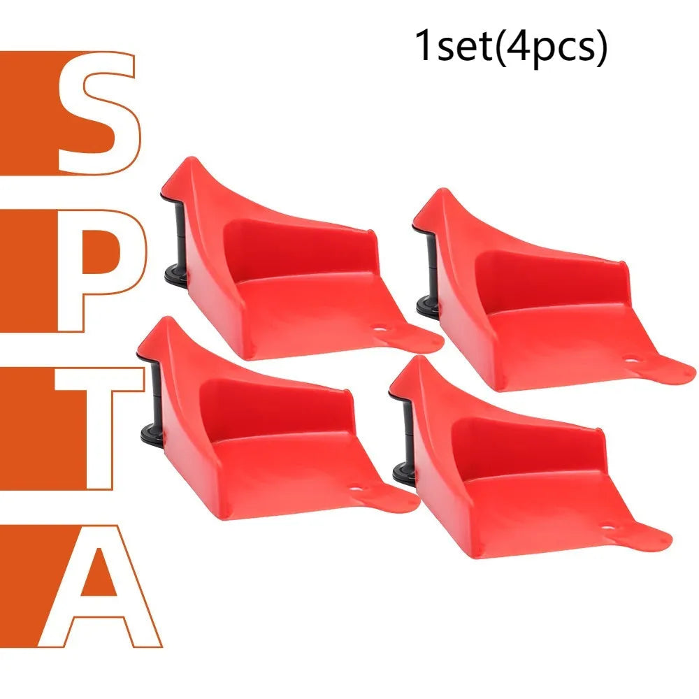 Four bright red triangular plastic parking blocks for car tyres