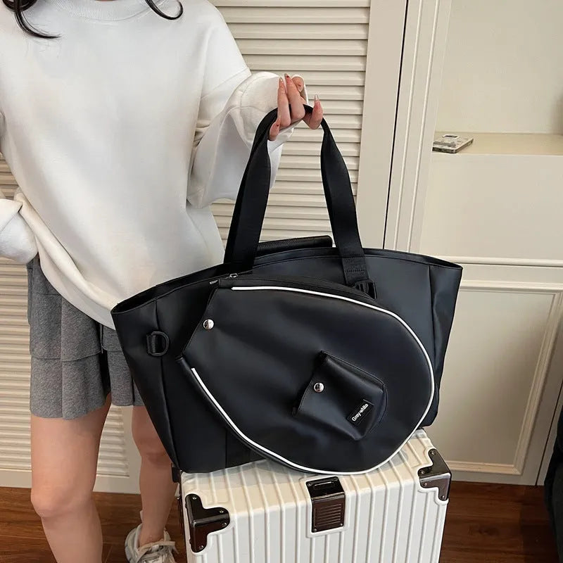 Large black yoga storage bag with one-shoulder strap showing generous capacity for workout gear