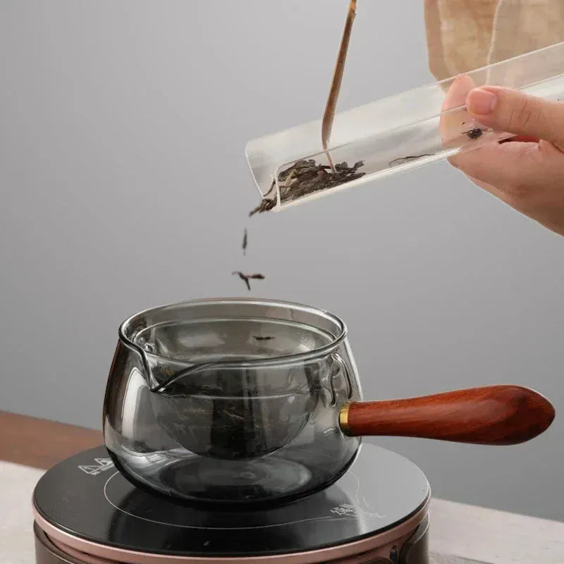 Rotating glass teapot with wooden handle and stainless steel infuser basket
