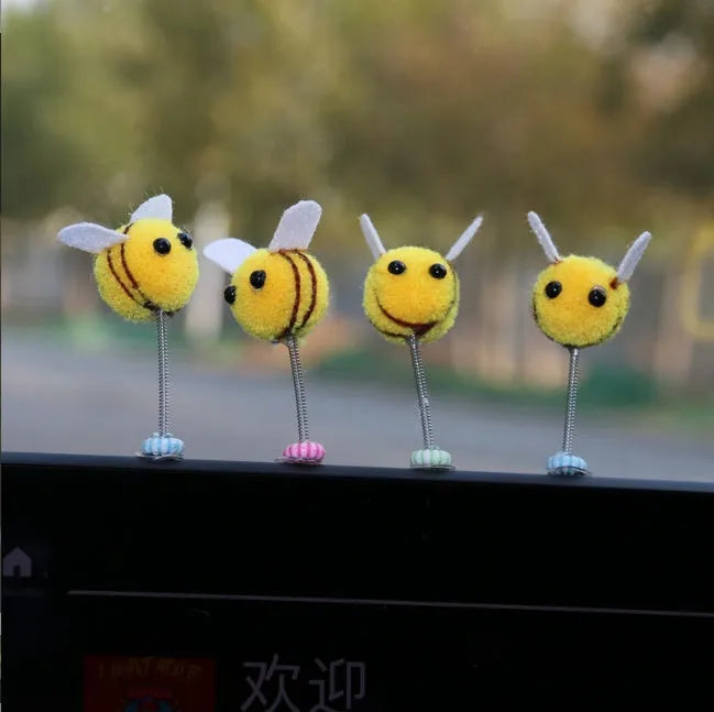 Swing Spring Bee soft fur ball car decoration with cartoon bee shape on adhesive backing.