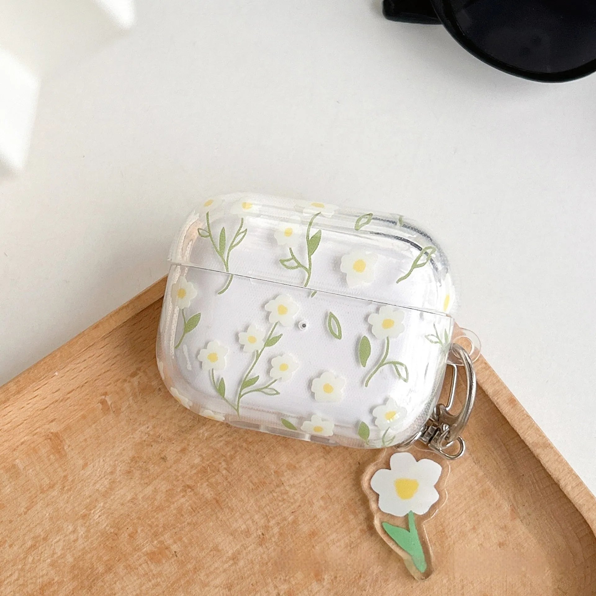White floral high-transparency TPU protective cover for Apple AirPods showing decorative patterns