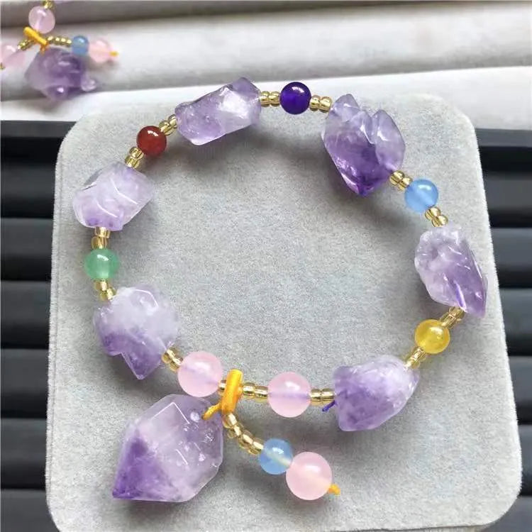Natural shaped purple amethyst bead bracelet with a fu character charm for women.