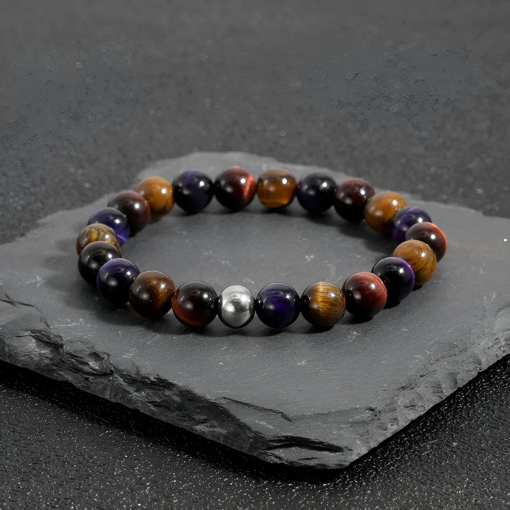 Minimalist elastic bracelet with a geometric natural tiger-eye stone in yellow, purple, or red.