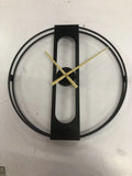 Round metal wall clock with 50 cm diameter in black or gold finish on a wall