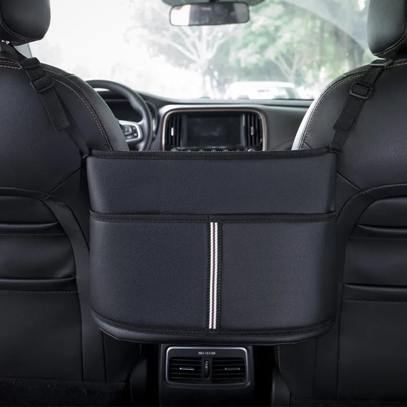 Black leather car seat hanging storage organiser for tissue boxes, shown between vehicle front seats.