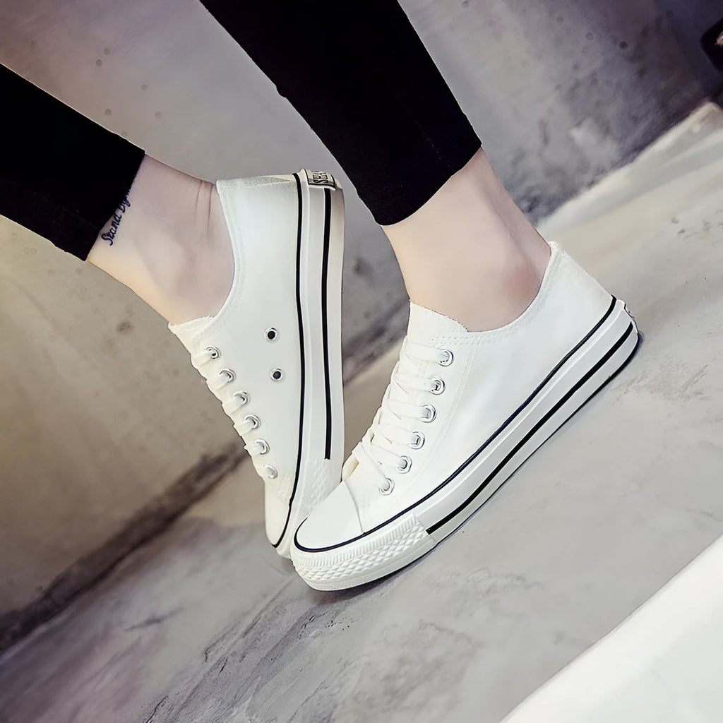 Women's solid colour canvas casual shoes shown in black, white black, white red, and all black.