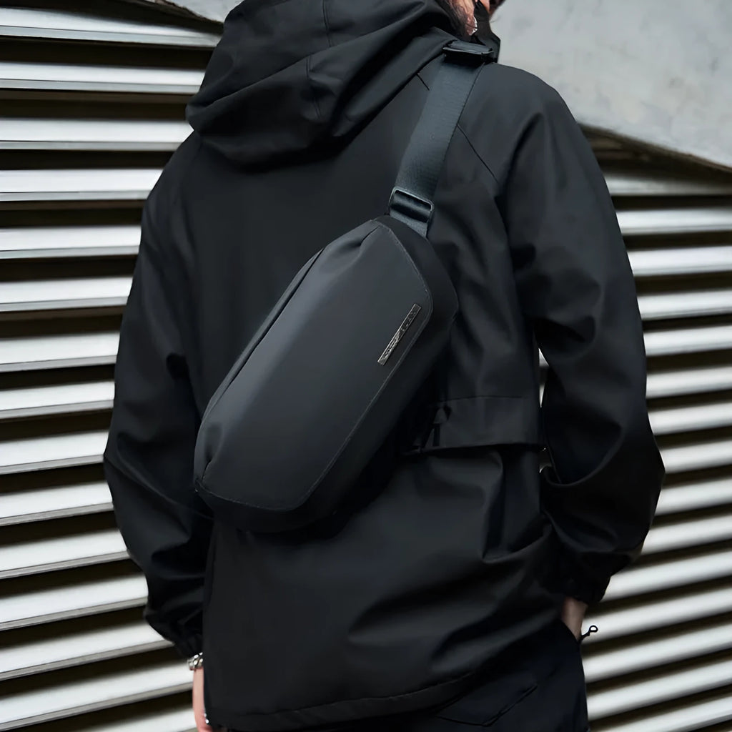 Men's black Oxford cloth messenger bag with a cross-body shoulder strap.