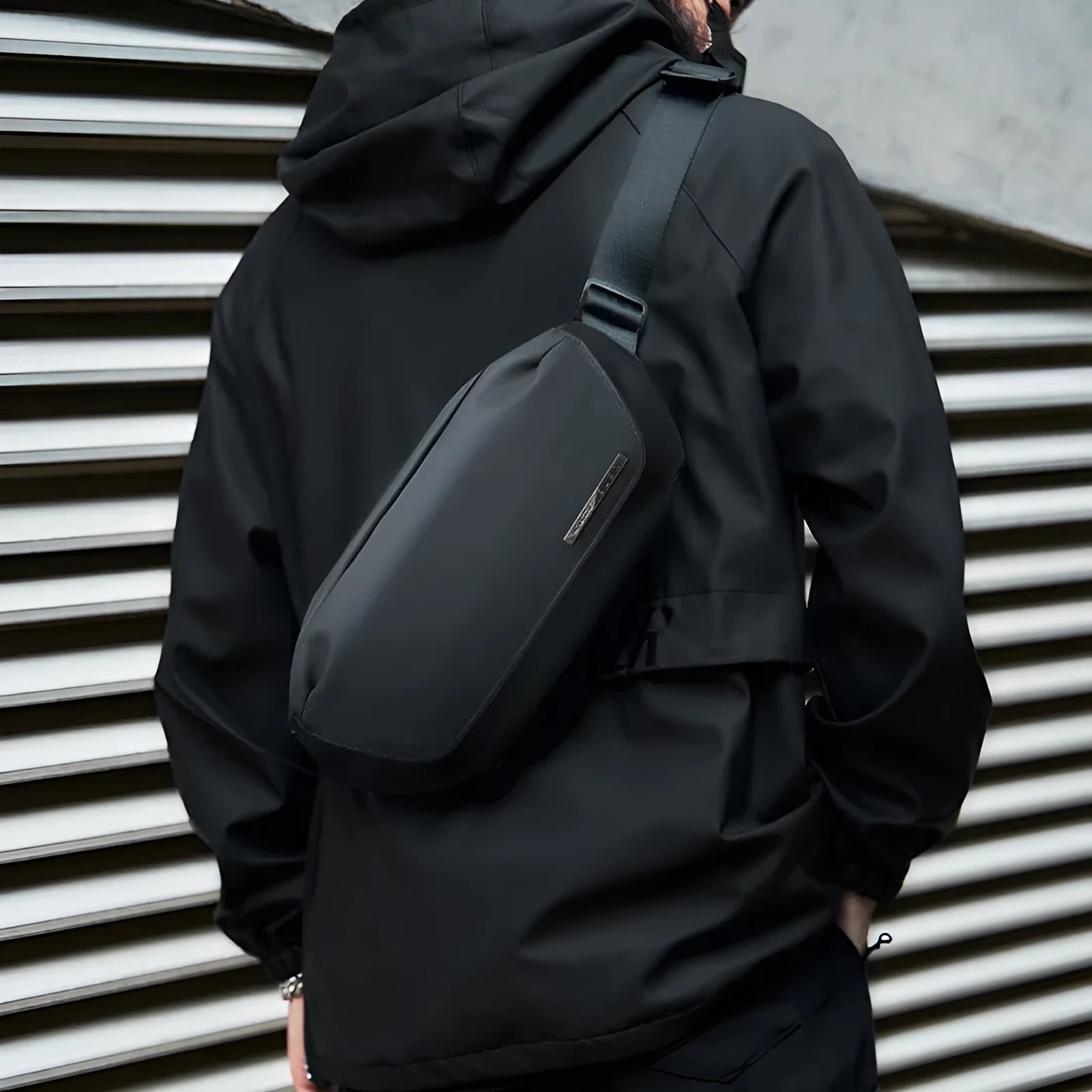 Men's black Oxford cloth messenger bag with a cross-body shoulder strap.