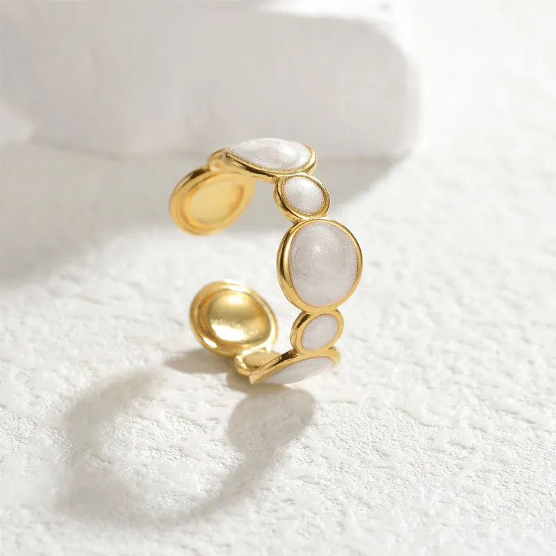 A geometric adjustable ring for women made of electroplated stainless steel on a plain background.