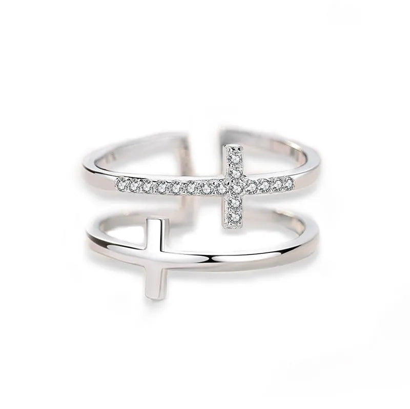 Women's adjustable copper ring featuring a miniature double cross design with sterling silver and zircon inlay.