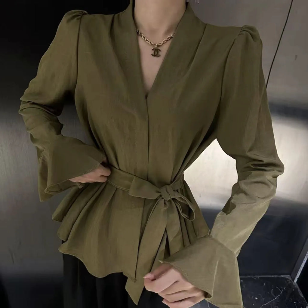 Women's black French-style shirt with an irregular collar and long bell sleeves.