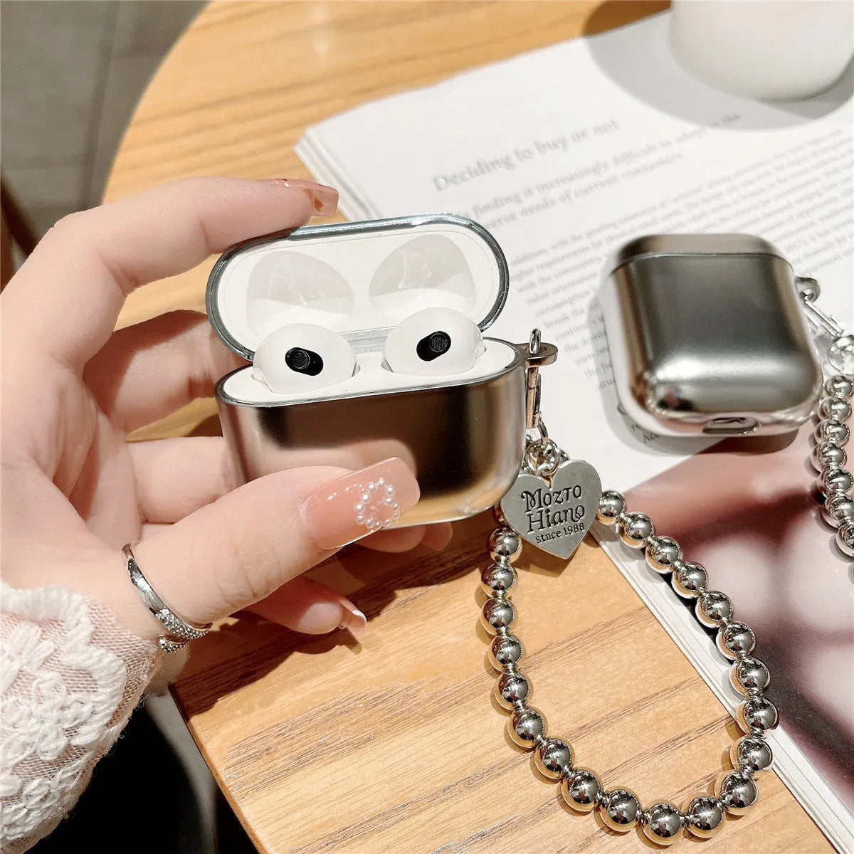 Matte plating TPU protective cover for Apple AirPods with an integrated carrying bracelet attached.