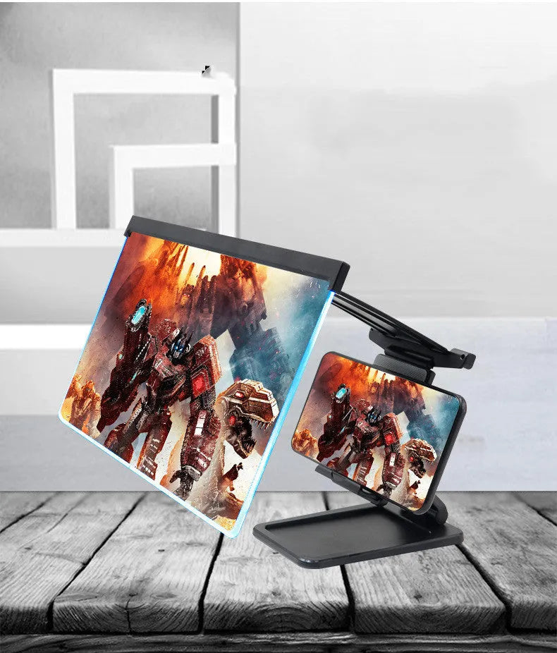 Black foldable mobile phone screen magnifier with a detachable phone holder on a desk.