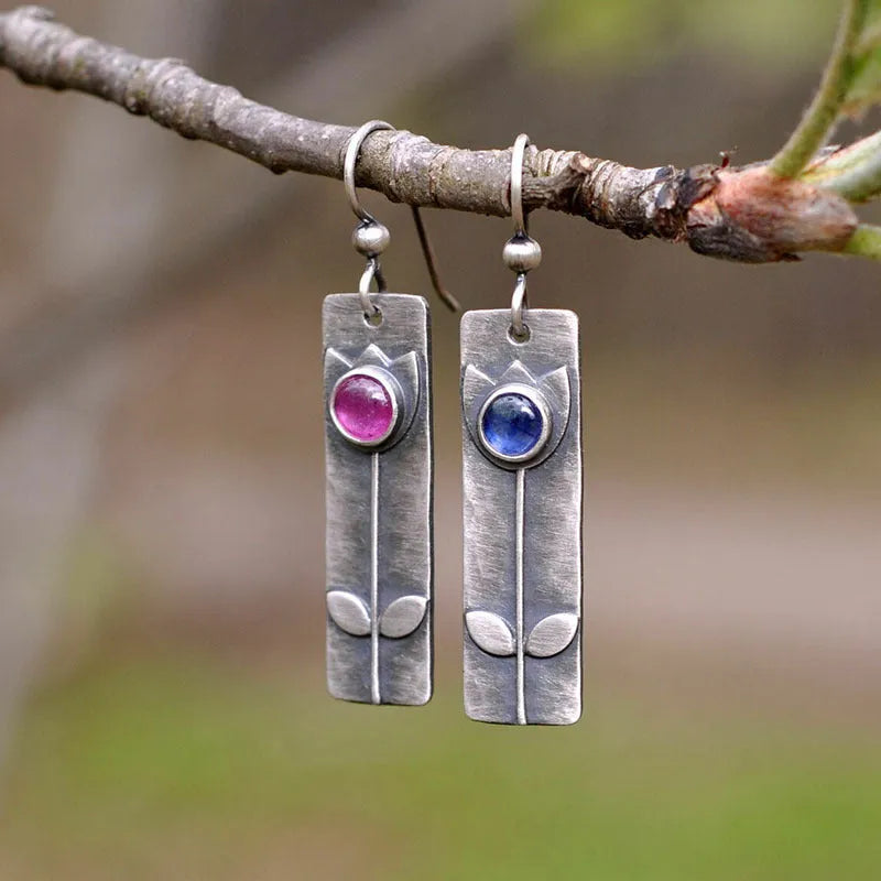 Antique finish geometric earrings with red sapphire stones and elliptical design elements