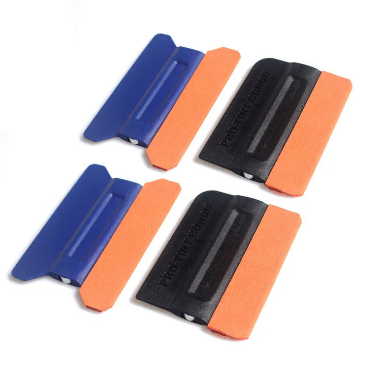 Car film application scraper tool with magnetic head and ABS handle on a work surface.