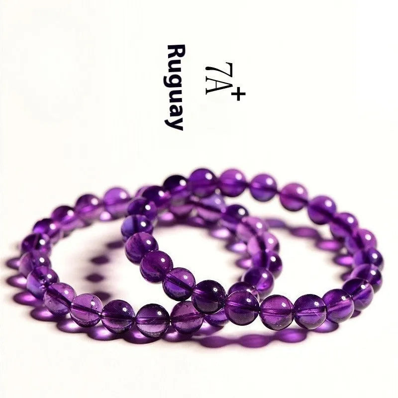 Natural Uruguayan amethyst crystal bead bracelet with polished scattered beads on a white background.