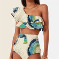 White women's one-shoulder swimsuit with a layered lotus leaf design skirt and high leg split.