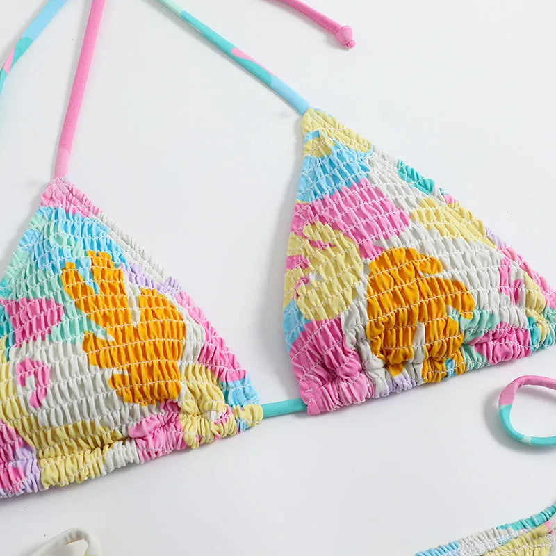 Women's floral print triangle bikini with smocking detail on the briefs, shown in multicolour.