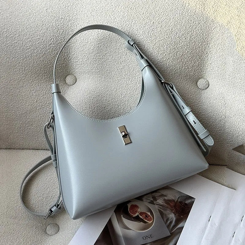 Genuine leather dumpling-shaped crossbody shoulder bag in apricot colour with street-trend details.