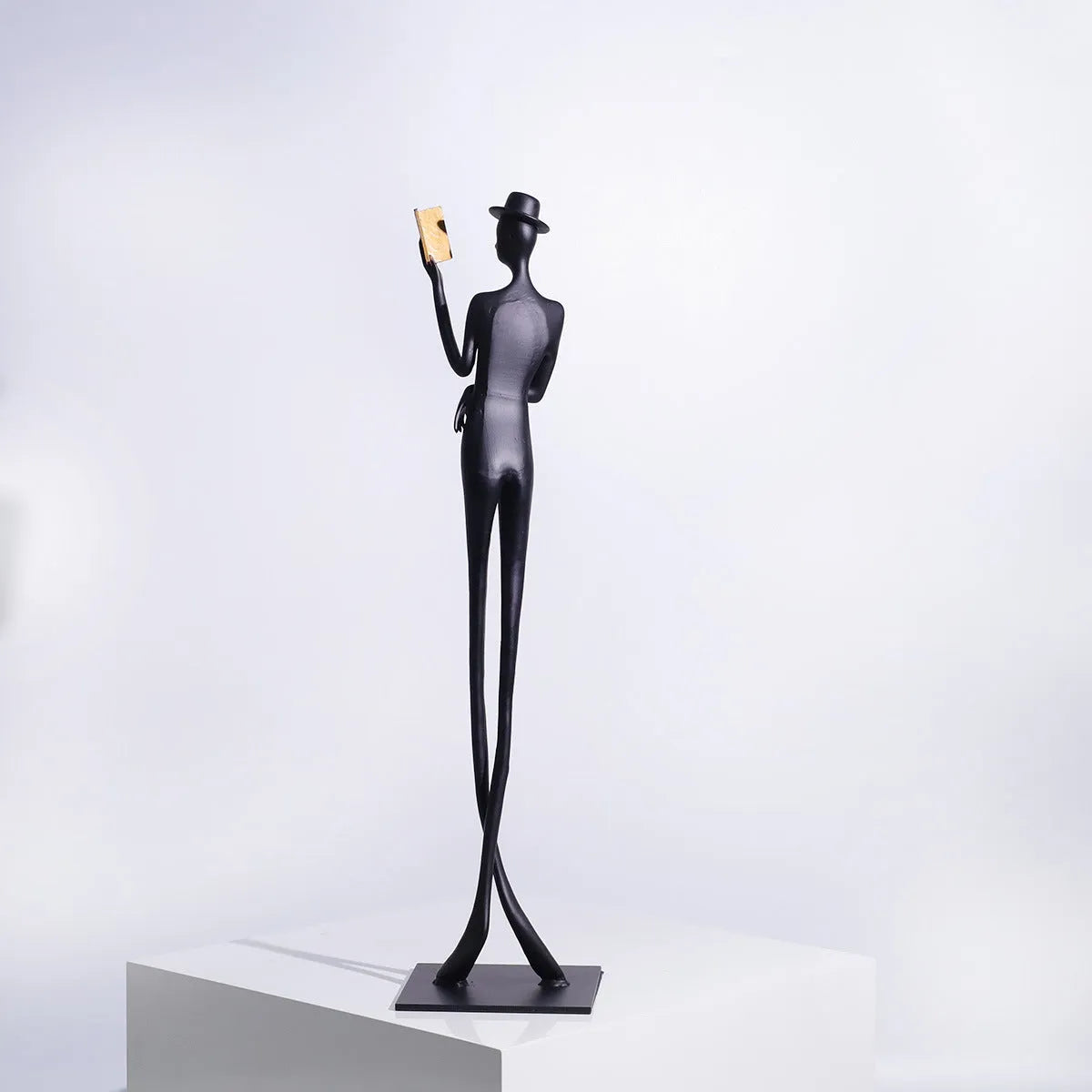 Black cast aluminium reading woman sculpture, 51cm tall modern desktop ornament.