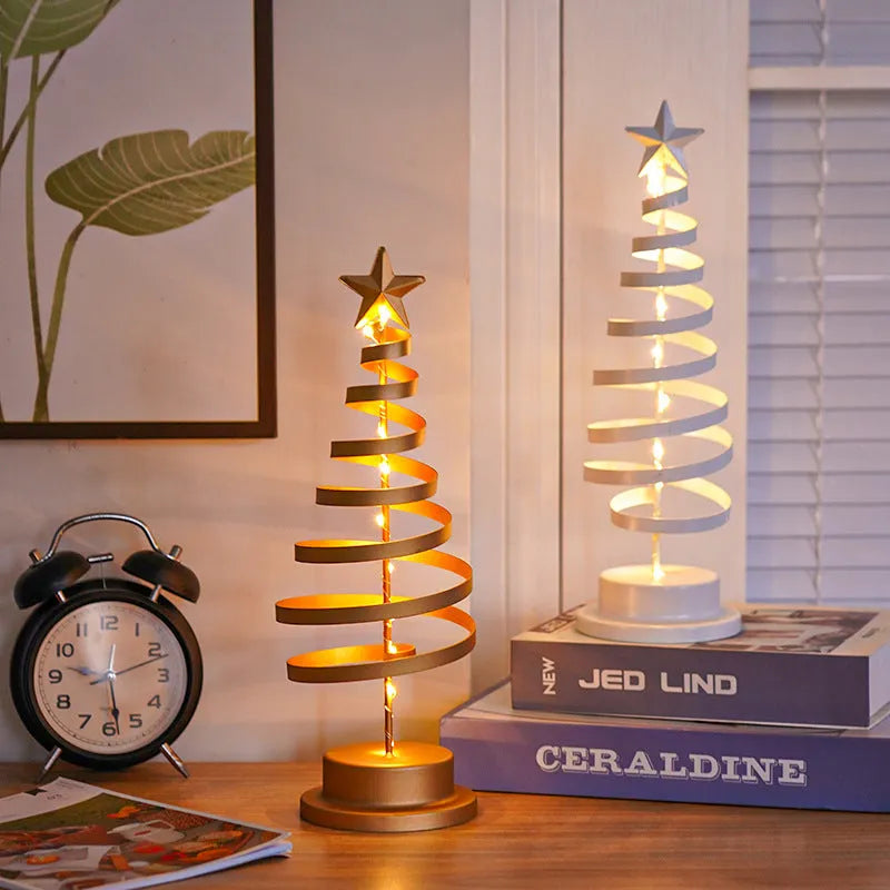 Wrought iron LED Christmas tree light with spiral design and warm white illumination on table