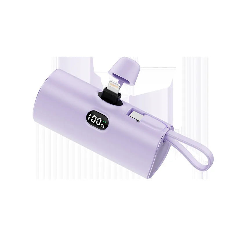 Compact capsule-shaped power bank in various colours showing digital display and built-in plug.