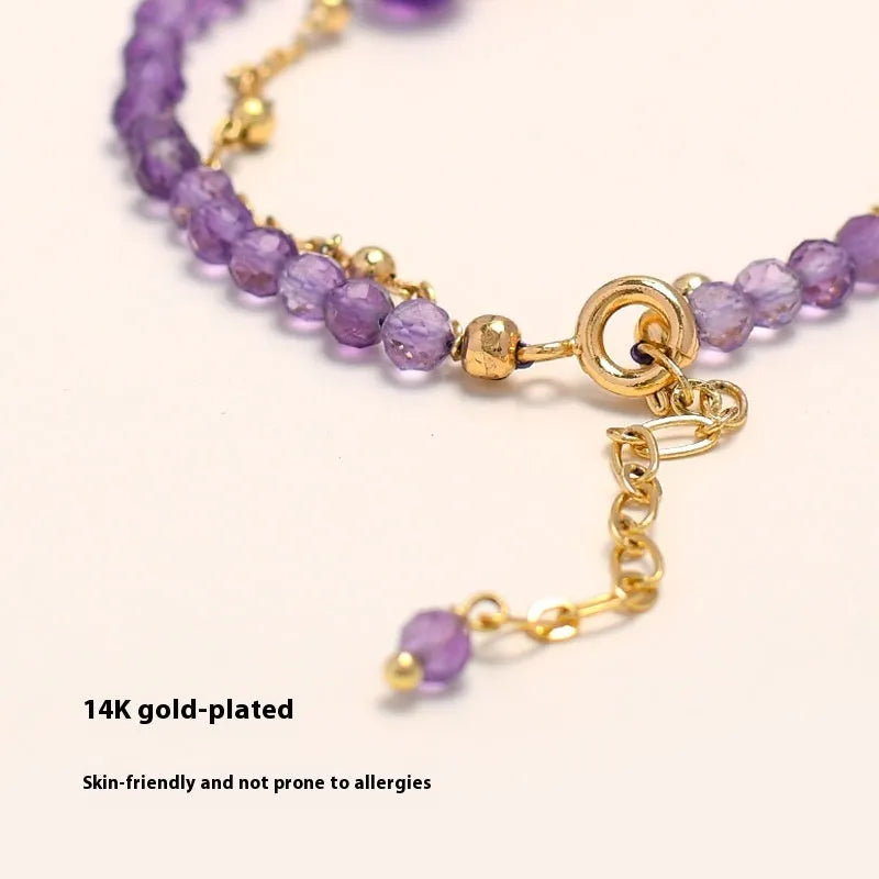 Close-up of a Chinese style women's bracelet with diamond-shaped amethyst crystals and an electroplated finish.
