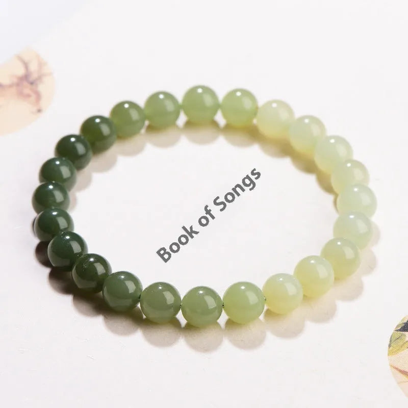 Natural gradient water Hetian jade bead bracelet showing round and barrel bead options on an adjustable string.