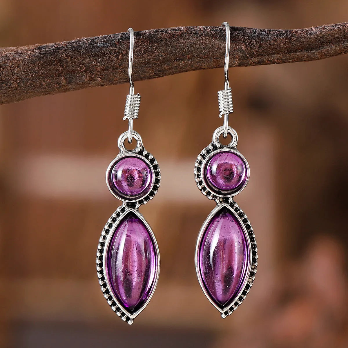 A pair of vintage geometric pendant earrings in black and purple with a Bohemian style.