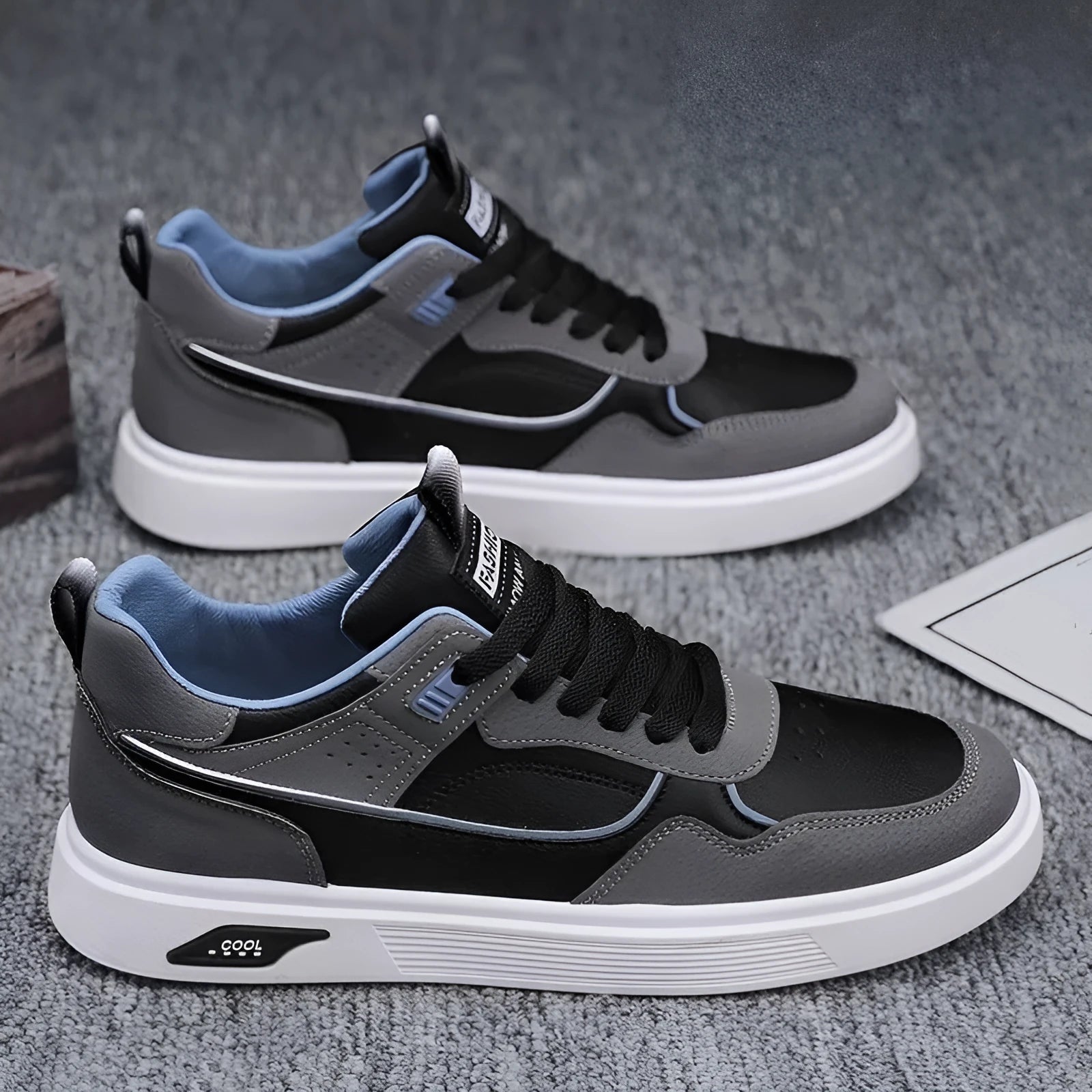 Men's low-top canvas board shoes in black, beige, or grey with round toe and leather stitching.