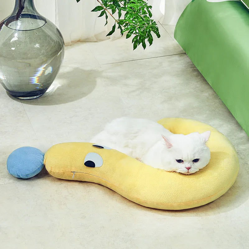 Blue rectangular dog pillow measuring 62 by 39 centimetres on a wooden floor.
