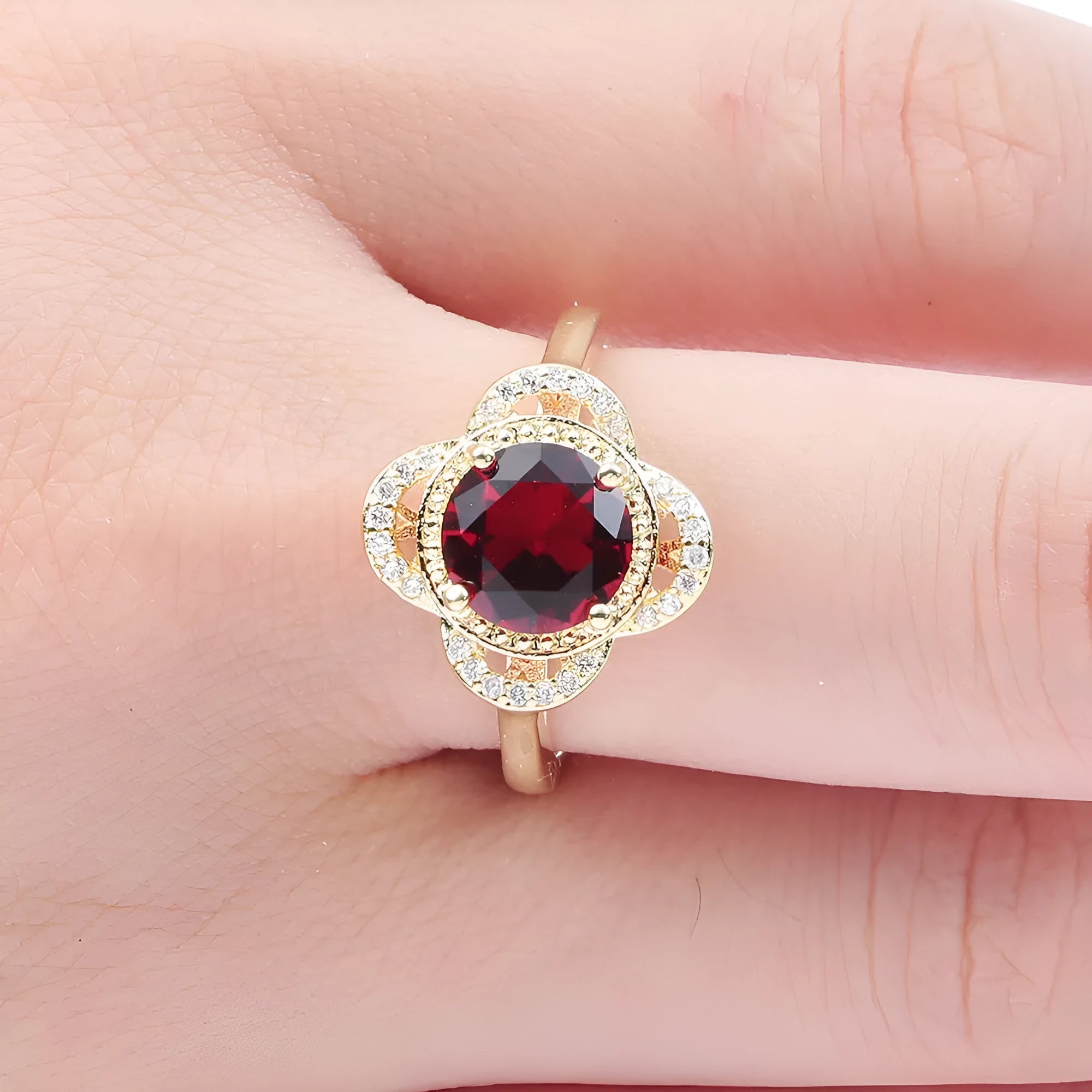 Copper fruit-shaped ring with a zircon stone, showing electroplated finish.