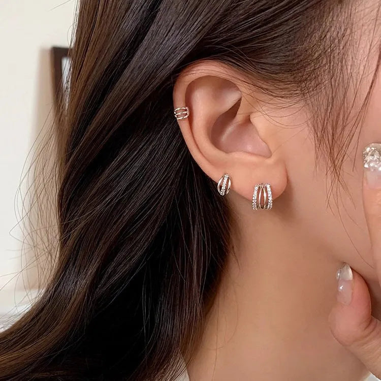 A pair of geometric design earrings made from 925 silver with an electroplated finish.