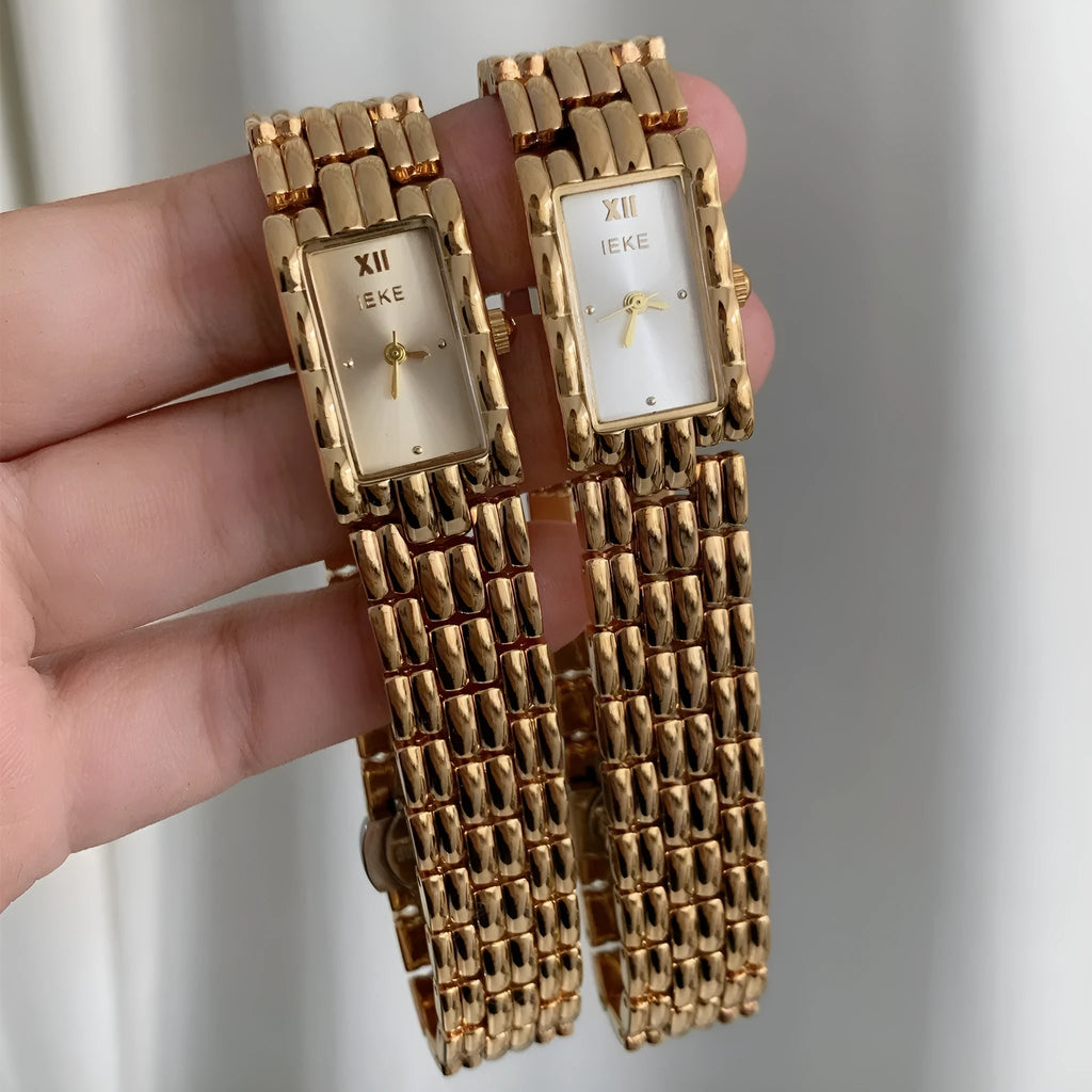 Women's mid-ancient bracelet watch with a 15mm silver dial and stainless steel strap.