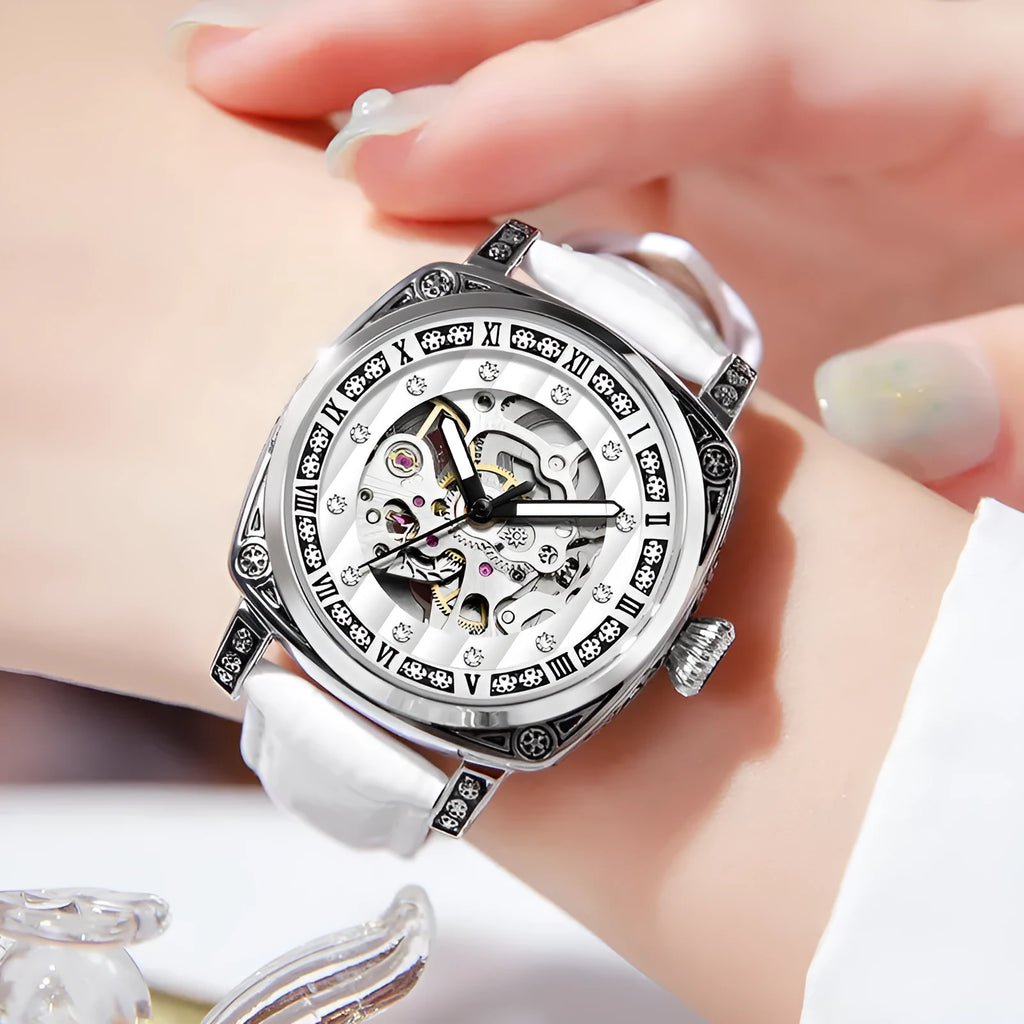 Mechanical watch with luminous hands on a leather strap, shown in black, red, steel, and white colour variants.