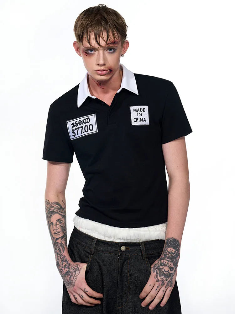 Black slim fit men's short sleeve polo shirt with embroidery detail on a hanger.