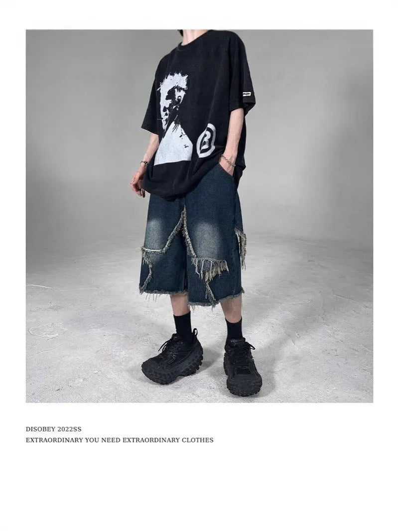Blue men's denim shorts with a loose fit, frayed hem, and an embroidered five-pointed star on the leg.