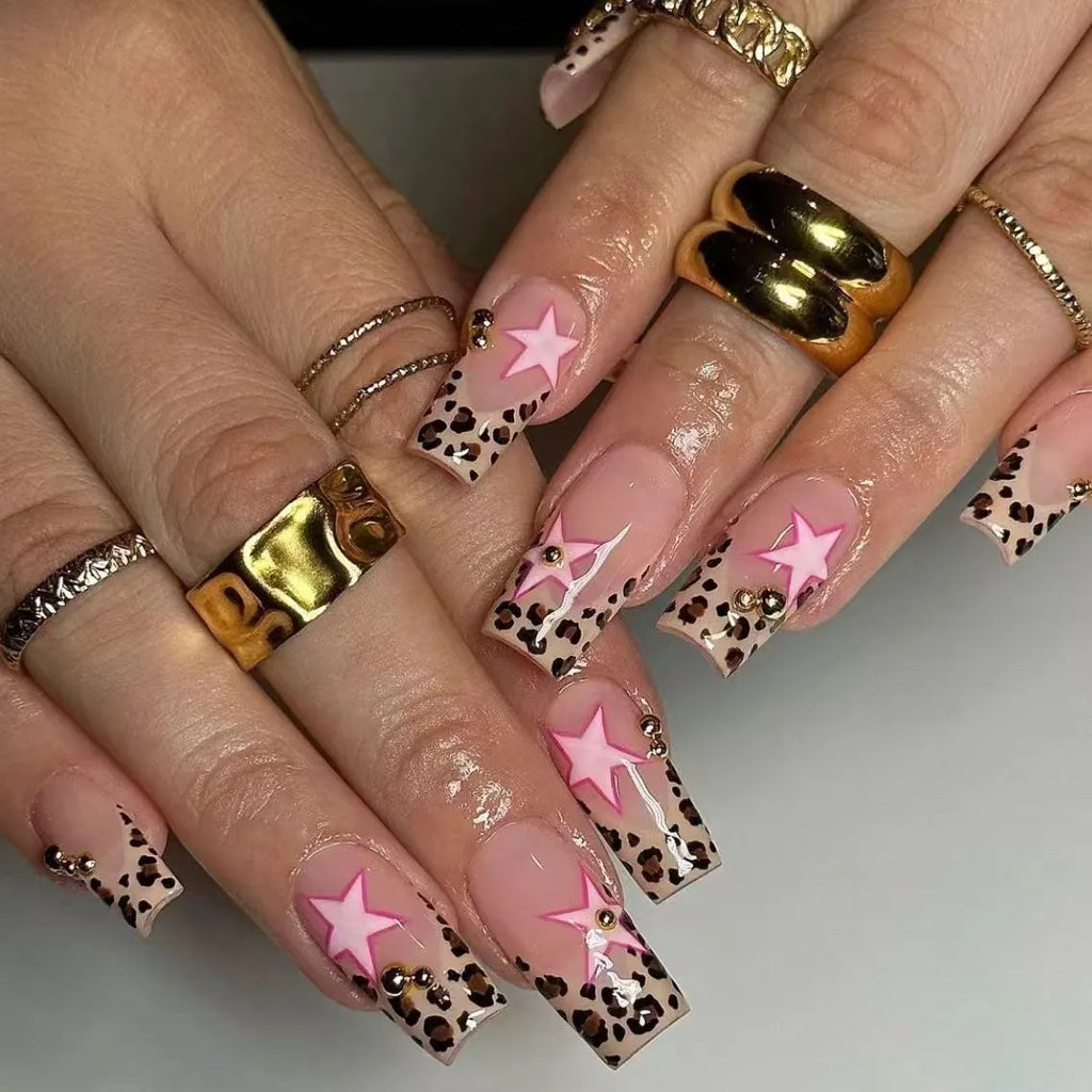 French leopard print nail art with five-pointed stars, pearl and diamond accents on wearable nail pieces